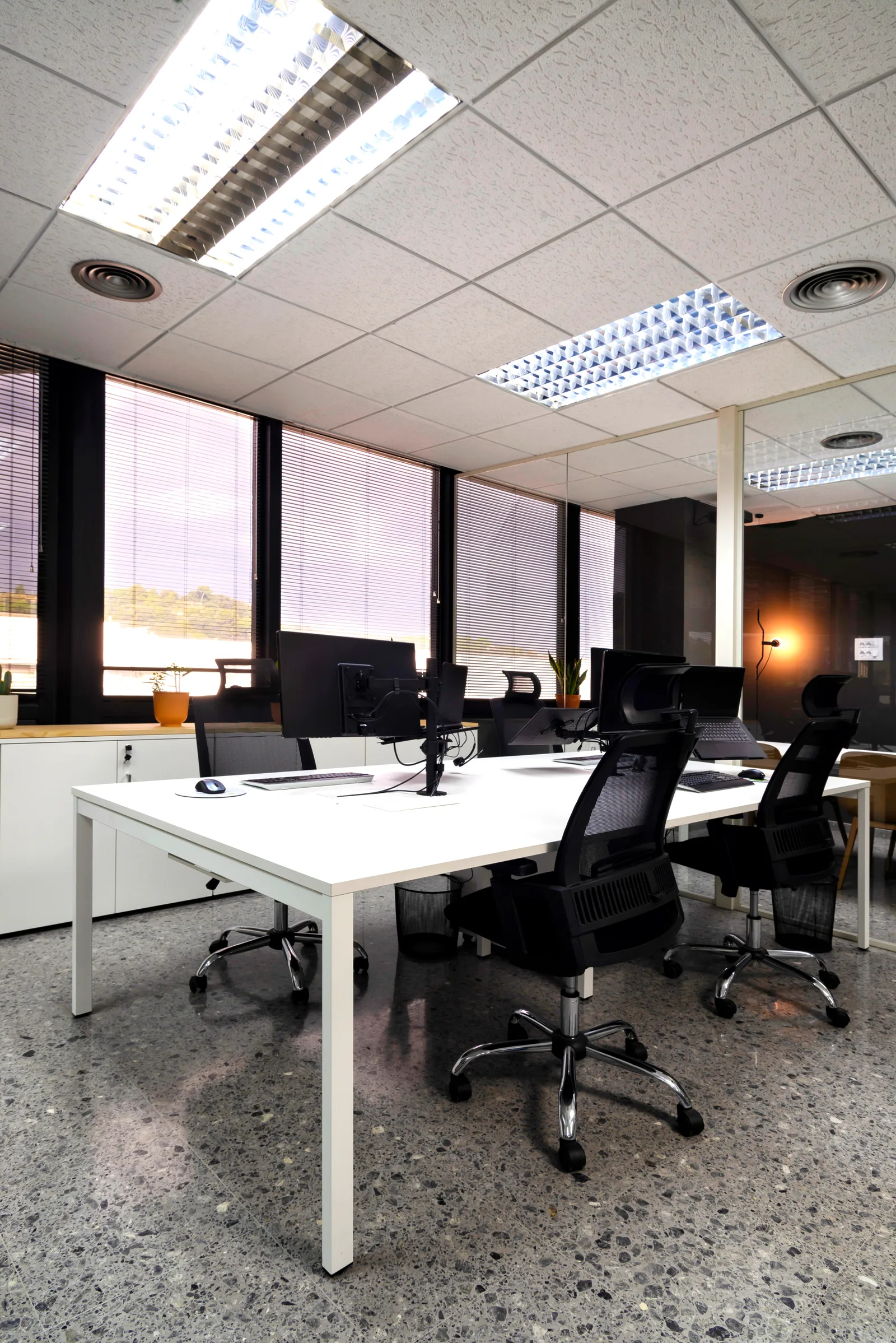 Modern office interior with white desks and computers